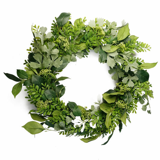 Artificial seasonal wreath with greenery hanging on a front door